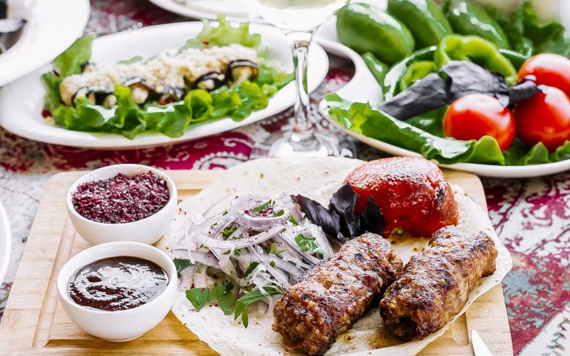 front view served table lula kebab on pita bread with onions and tomato